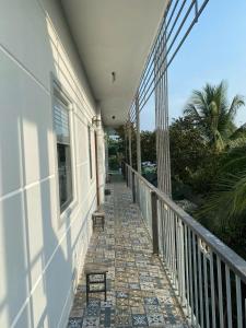 a balcony with two benches on a house at Homestay canthoriver in Ấp Bình Lạc