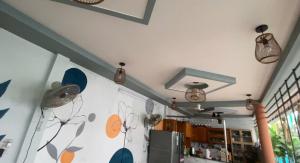 a kitchen with a wall painted with flowers on it at Homestay canthoriver in Ấp Bình Lạc