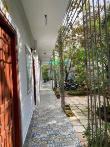 an arched doorway to a building with a walkway at Homestay canthoriver in Ấp Bình Lạc