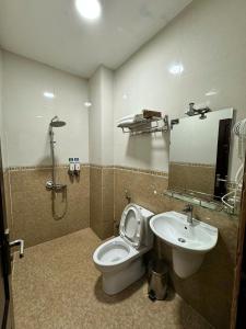 a bathroom with a toilet and a sink at Tommy hotel khe sanh dalat in Da Lat +42 photos
