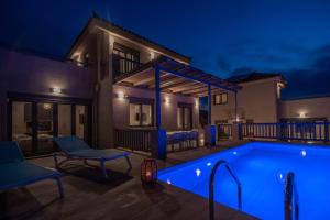 a villa with a swimming pool at night at Elafonisos Aqua Villa IV in Elafonisos