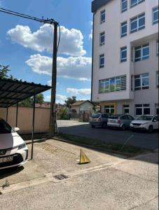 a yellow triangle on the ground in front of a building at PARK Apartment in Bijeljina