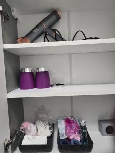 a shelf with a hair dryer and other items on it at Jmr in Uelzen