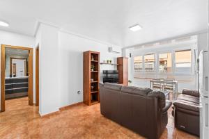 a living room with a couch and a kitchen at Zoa in Torrevieja +13 photos
