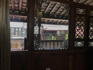 a view through a window of a building at Baisha Holiday Resort Lijiang in Lijiang