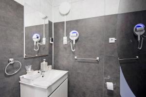 a bathroom with a shower and a sink and a mirror at Casa da Ponte in Lombinha +36 photos