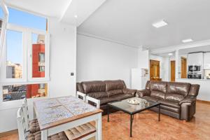 a living room with a couch and a table at Zoa in Torrevieja