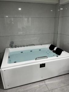 a large white bath tub in a room at Hotel Krishna Palace in Pālanpur