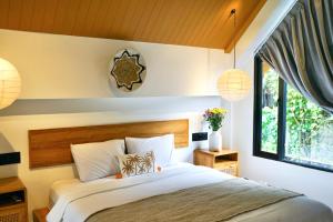 a bedroom with a bed and a window at Dzen Greenfield Villa 6 in Ubud +56 photos