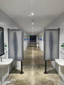 a bathroom with two sinks and two urinals at Charlie's Hangar Surf Hostel in San Juan