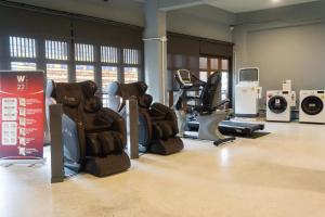 a gym with treadmills and exercise equipment in it at W22 by Burasari in Bangkok