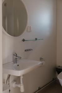 a bathroom with a white sink and a mirror at Mösseberg Camping in Falköping +12 photos