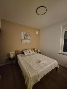 a bedroom with a large bed with a blanket on it at Gala Lenassi in Kamnik