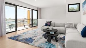 a living room with a couch and a table at Fleetwood Atelier in Frankston South