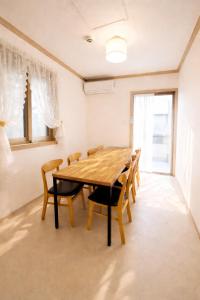 a dining room with a wooden table and chairs at 전주한옥마을 스테이네슬 in Jeonju +18 photos
