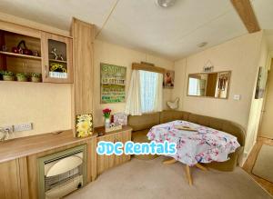 a small bedroom with a bed and a tv at Palins - KC19 in Kinmel Bay
