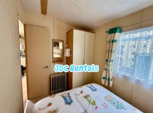 a bedroom with a bed and a window at Palins - KC19 in Kinmel Bay +7 photos