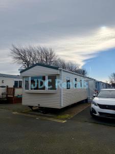 a dog trailer parked in a parking lot with a car at Palins - KC19 in Kinmel Bay
