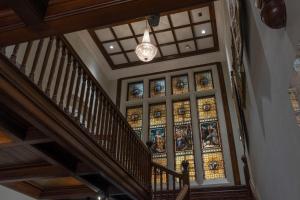 a hallway with a large stained glass window at Newton Park Country House Hotel in Burton upon Trent +73 photos