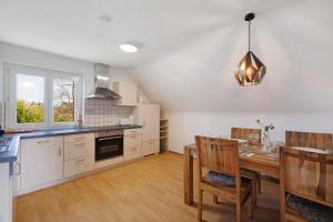 a kitchen with a table and a dining room at Appartement Panoramablick in Lustenau