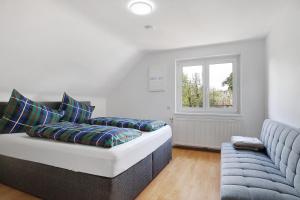a living room with a couch and a window at Appartement Panoramablick in Lustenau