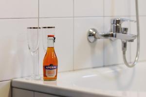 a bottle of beer sitting on a counter next to a glass at Appartement Panoramablick in Lustenau +25 photos