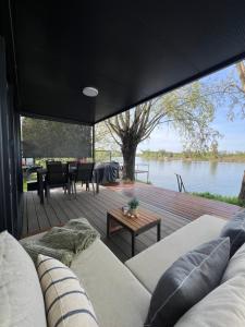 a living room with a couch and a view of the water at Altair House in Mošorin
