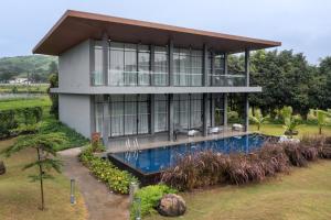 a house with a swimming pool in front of it at Beyond by Sula in Nashik
