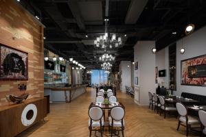 a restaurant with tables and chairs and a bar at Hard Rock Hotel Shenzhen in Shenzhen