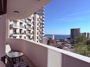 a balcony with a table and chairs on a building at Luxury 2BR Sea View & Garage & Twin Towers Becici in Bečići