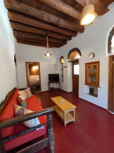 a living room with a couch and a table at Ktima Kariofillis in Révmata