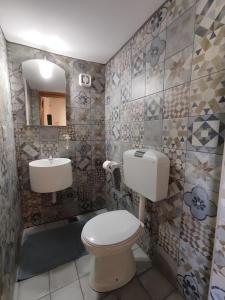 a bathroom with a toilet and a sink at Ktima Kariofillis in Révmata +29 photos