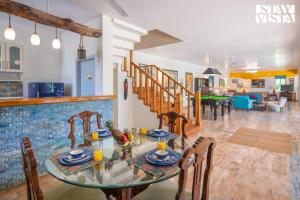 a dining room and living room with a table and chairs at StayVista at The Hideout Farms with Lawn and private Pool in Kurukshetra