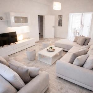a living room with white furniture and a flat screen tv at Relax Villa with Pool in Bihać