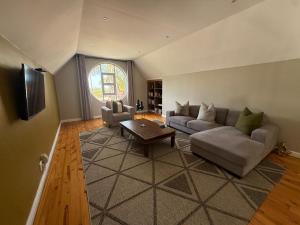 a living room with a couch and a table at The Nathaniel in Blue Bend
