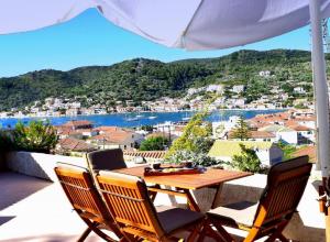 a table and chairs on a balcony with a view at Tilemachos Traditional House in Vathi