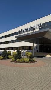 a building with a sign on the side of it at Hotel Rivo Timisoara in Timişoara