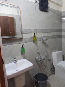 a bathroom with a sink and a toilet and a mirror at Tara inn in Alwaye +17 photos