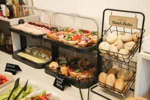 a buffet with several trays of different types of food at Penzión Hoffer in Nitra