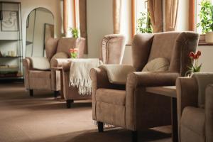 a living room with two chairs and a table at Penzión Hoffer in Nitra