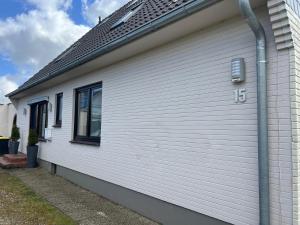 a white house with the number on it at Schöne Wohnung Mit Dem Garten in Jübek +7 photos