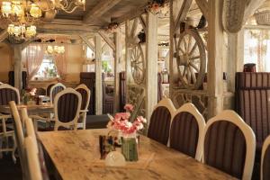 a dining room with a wooden table and chairs at Penzión Hoffer in Nitra