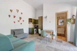 a living room with a couch and a table at Casa Kim - Capoliveri in Capoliveri