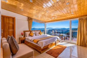 a bedroom with a bed and a balcony at Vamitag Inn in Shimla