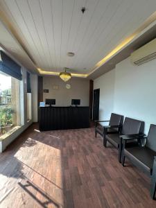 an empty waiting room with chairs and a desk at Hotel KG Estate in Jaipur