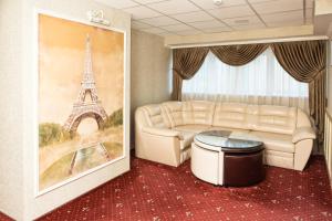 a living room with a couch and a rug at Lazurny Bereg Hotel in Tyumen