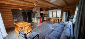 a living room with a couch and a table at Palmas in Jūrkalne