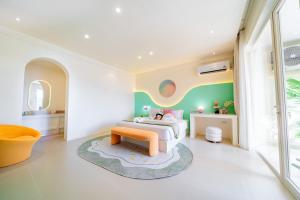 a childrens bedroom with a bed and a table at Candy House Private Pool Villa & KTV in Ban Nong Chaeng +11 photos