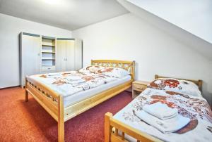 a bedroom with two beds and a closet at U Jeřába - komplex B in Horní Věstonice