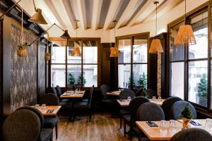 a restaurant with tables and chairs and windows at Les Initiés in Rouen +16 photos